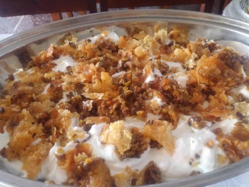 a bowl ofatmeal with a topping on top of it at Anatoli Hotel in Agia Marina Aegina