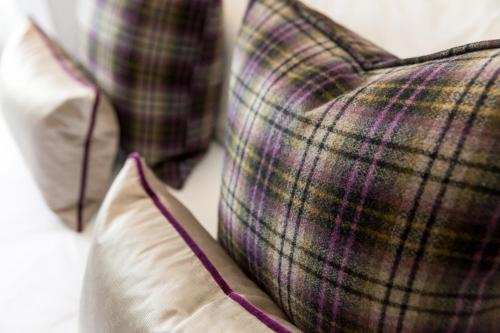 two pillows sitting next to each other on a couch at The Dowans Hotel of Speyside in Aberlour