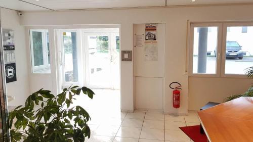 a front door of a building with a fire extinguisher at Hotel Pension Kaempfelbach in Kämpfelbach