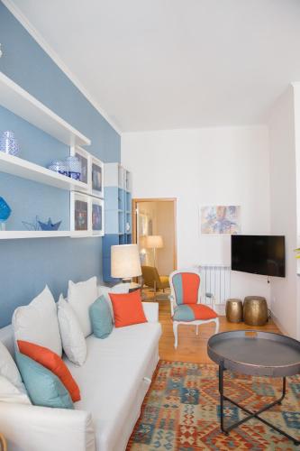 a living room with a white couch and a table at Rent4Rest - Lisbon Downtown Designer's Apartment in Lisbon