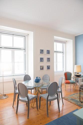 a dining room with a glass table and chairs at Rent4Rest - Lisbon Downtown Designer's Apartment in Lisbon