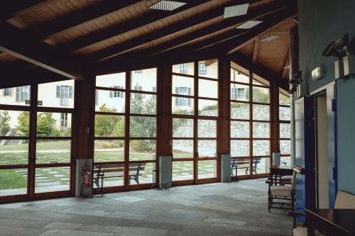 a large room with large windows in a building at Certosa 1515 in Avigliana