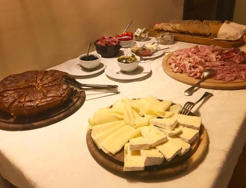 a table with cheese and other foods on it at Agriturismo Antica Dimora Del Turco in Sona