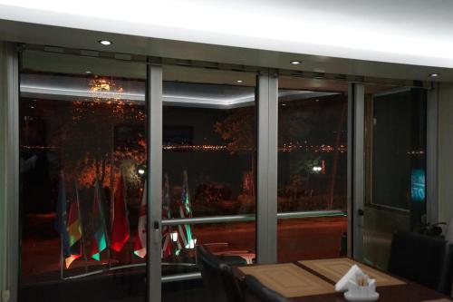 a restaurant with a view of the city from a window at Yalihan Ari Hotel in Unye