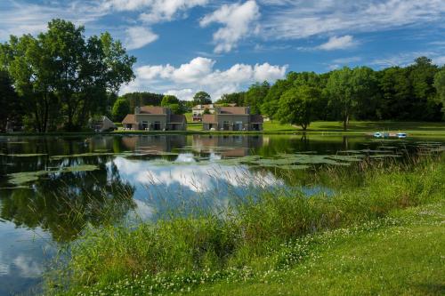 a house on the shore of a lake at Tamarack Wisconsin Dells, a Ramada by Wyndham in Wisconsin Dells