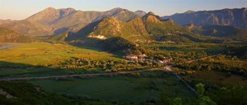 an aerial view of a valley with mountains in the background at Country House Djurisic in Virpazar