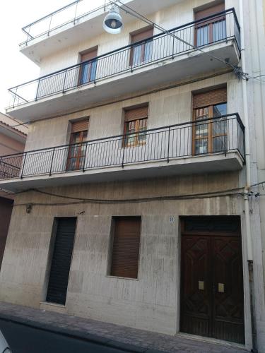 an apartment building with a balcony and two doors at B&B Cavour in Carlentini