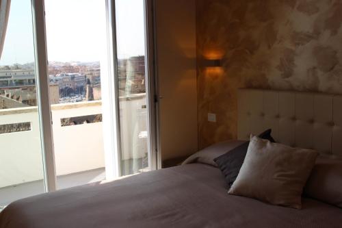 a bedroom with a bed and a large window at Windows on Rome in Rome