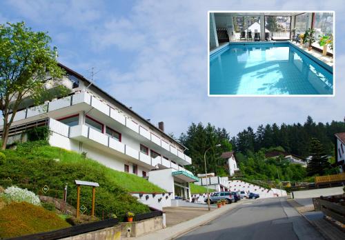 a picture of a building with a swimming pool at Hotel Pension Jägerstieg in Bad Grund