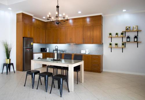 a kitchen with a table and chairs in a kitchen at Tortuga Villas Pattaya in Pattaya South