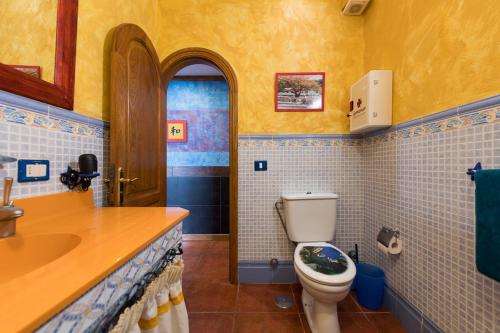a bathroom with a toilet and a sink at Seaview Faro Arinaga in Arinaga