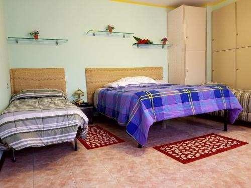a bedroom with two beds and two rugs at Bed And Breakfast Adrj in Cavriago