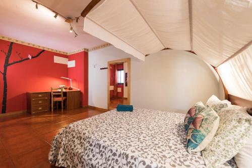 a bedroom with a large bed and a desk at Seaview Faro Arinaga in Arinaga