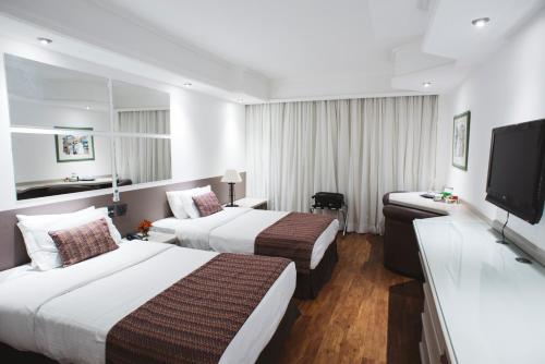 Кровать или кровати в номере Hotel Golden Park Campinas Cambuí By Nacional Inn