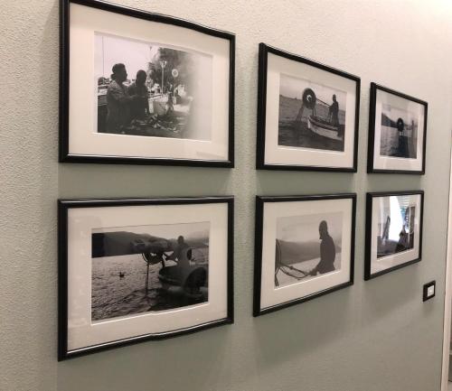 a group of pictures hanging on a wall at da Benedetta in Monterosso al Mare