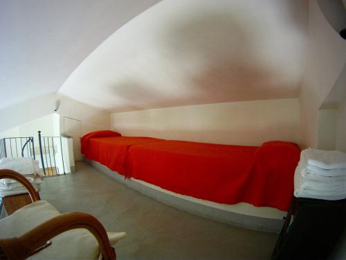 a bedroom with a red bed in a room at Agriturismo Valle Siriaca in Castelnuovo di Porto