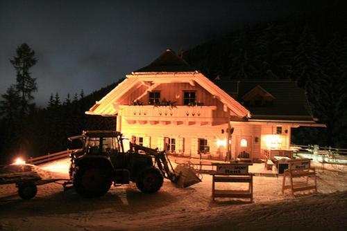 a tractor parked in front of a house at night at Unterwirt in Bad Kleinkirchheim