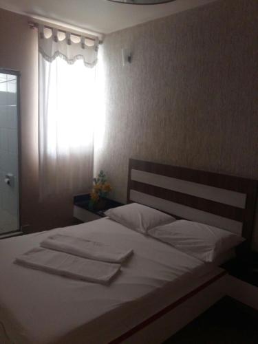 貝洛奧里藏特的住宿－Motel Delamar (Adult Only)，一间卧室配有一张带白色床单的床和一扇窗户。