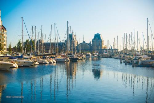 a group of boats docked in a harbor with buildings at ibis budget Brugge Jabbeke in Jabbeke