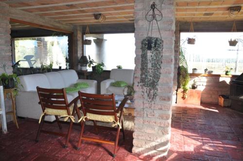 a living room filled with furniture and a fire place at Pousada Estalagem da Colina in Cambará