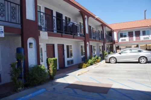 a car parked in a parking lot in front of a building at Beach Inn in Long Beach