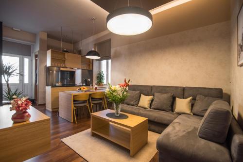 a living room and kitchen with a couch and a table at Luxury Apartments Centre of Opatija in Opatija