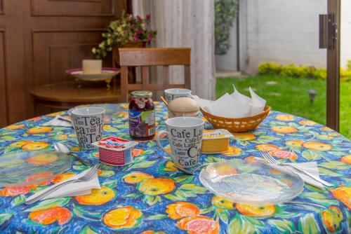 a table with plates of food on top of it at Colibrí B&B in Mexico City