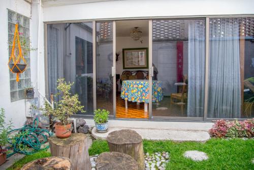 a sliding glass door of a house with a table at Colibrí B&B in Mexico City
