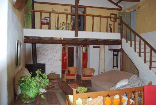 a living room with a spiral staircase in a house at Casa Rural La Alameda in Madridejos