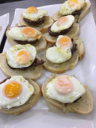 a plate of eggs on top of biscuits at Hotel Frijon in Aceuchal