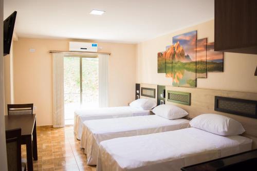 Ένα ή περισσότερα κρεβάτια σε δωμάτιο στο Austral Hotel
