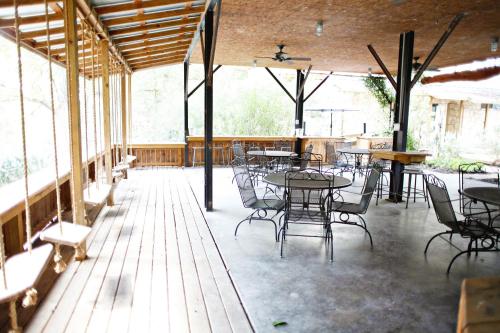 a patio with tables and chairs in a building at Tiki on the Rio in Third Crossing