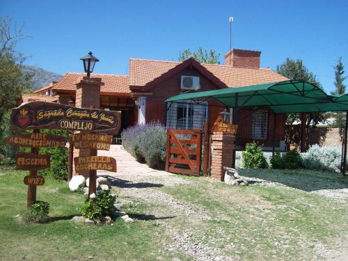 a sign in front of a house at Complejo Sagrado Corazón in Merlo