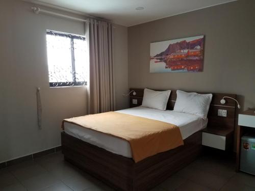 a bedroom with a large bed in a room at Lee Hotel in Ho Chi Minh City