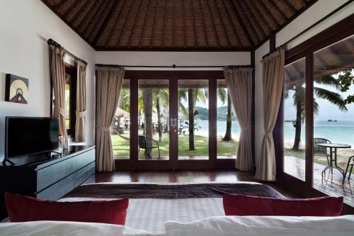 a bedroom with a view of the ocean at Mali Resort Pattaya Beach Koh Lipe in Ko Lipe