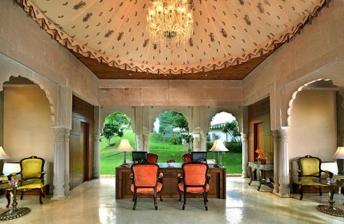 a room with a table and chairs and a chandelier at Rajasthali Resort & Spa in Jaipur