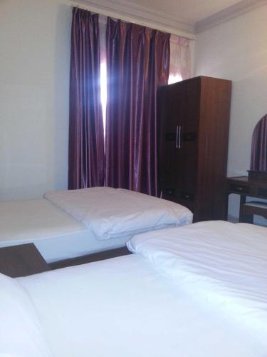 Ένα ή περισσότερα κρεβάτια σε δωμάτιο στο Paradise Inn Hotel (Tabasum Group)