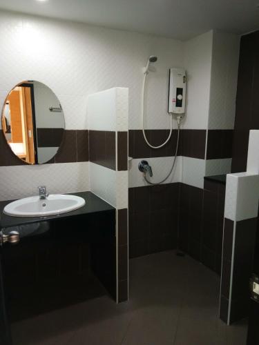 a bathroom with a sink and a shower at TK mansion Hat Yai in Hat Yai