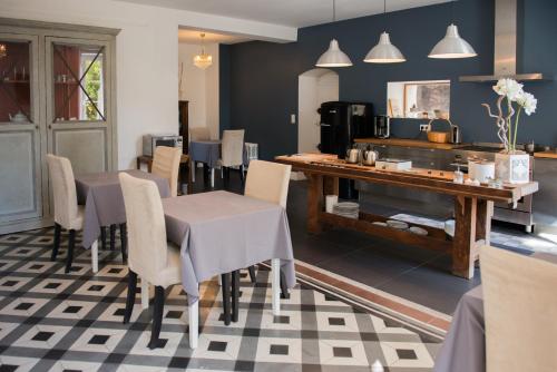 a dining room with a table and chairs at La Saudade in Saint-Péray