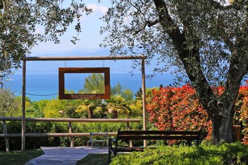 a swing in a park with a view of the ocean at Piani di Clodia Holidaypark in Lazise