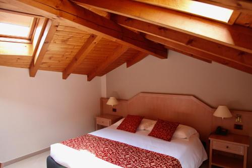 a bedroom with a bed in a room with wooden ceilings at Santanna in Verbania