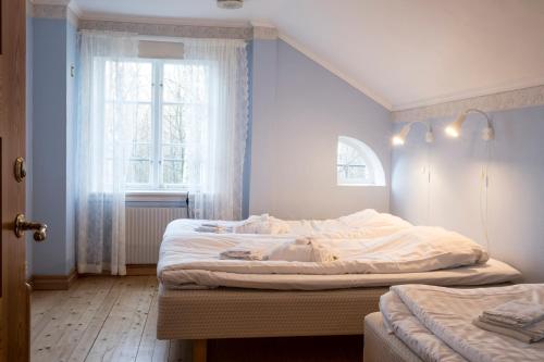 Кровать или кровати в номере Nordiska Folkhögskolan Bed and Breakfast