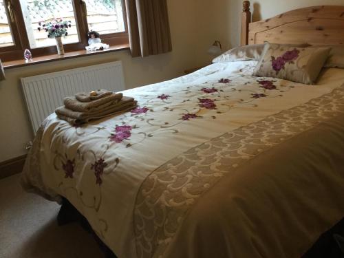 a bedroom with a large bed with flowers on it at Carinya in Talgarth
