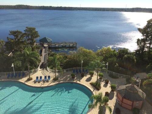 an aerial view of a swimming pool next to the water at Penthouse Blue Heron Condo in Orlando