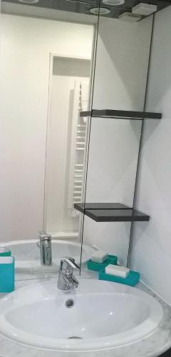 a bathroom sink with a mirror and a sink at LOCATIONS RIVES DE SEUGNE - Claveau in Jonzac