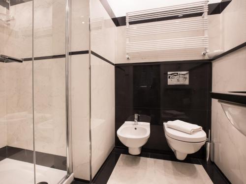 a bathroom with a toilet and a glass shower at da Benedetta in Monterosso al Mare