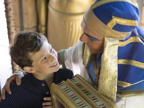 a woman playing the accordion with a young boy at Gardaland Adventure Hotel in Castelnuovo del Garda
