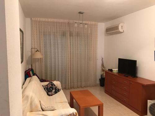 
a living room filled with furniture and a tv at Apartamento en Oropesa del Mar in Oropesa del Mar
