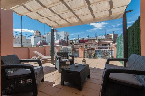 a patio with chairs and a table on a balcony at Hotel RH Sorolla Centro in Valencia