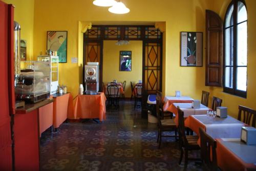 a restaurant with tables and chairs in a room at Hotel Europa in Perugia